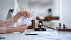 Divorced woman holding envelope with alimony, savings for single mom, allowance